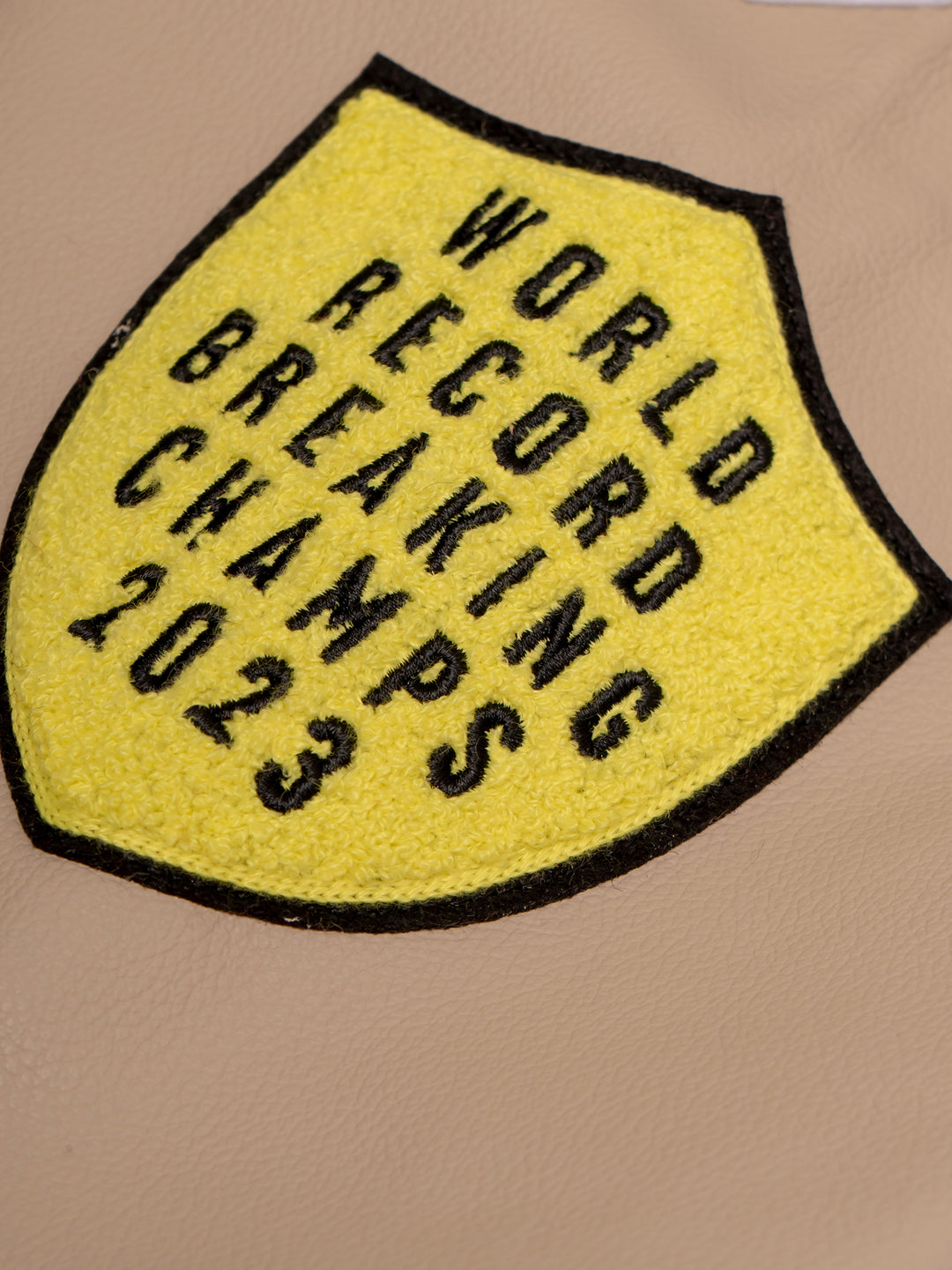 close up of a yellow patch on the sleeve of the jacket
