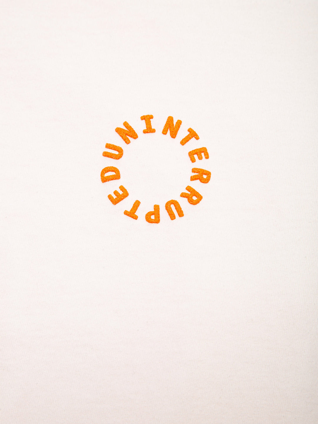 MORE THAN A VOYAGE ATTRIBUTE TEE OFF WHITE- detail picture of the UNITERRUPTED embroidery